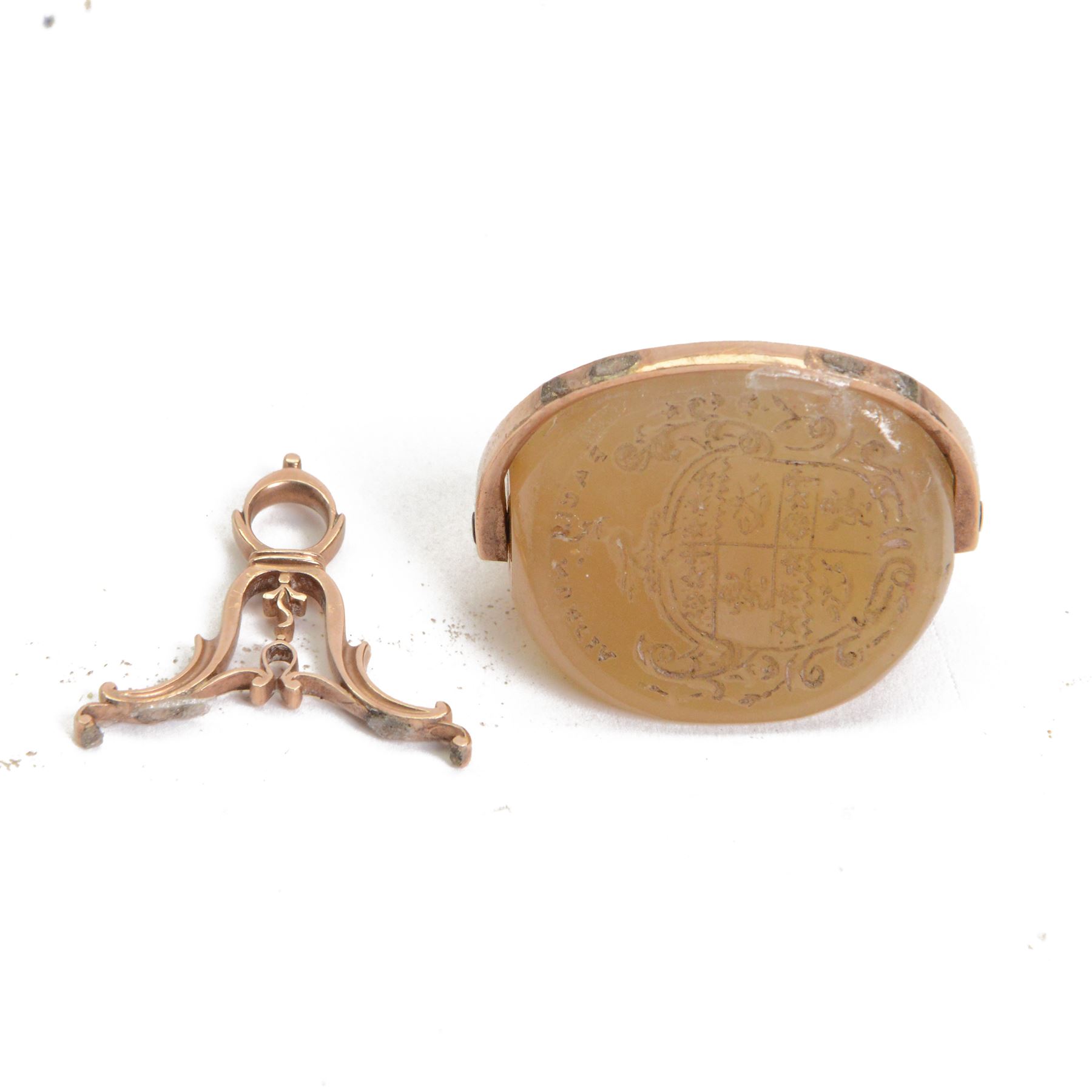 19th century 9ct gold agate triple swivel seal fob, each side engraved with armorial shield, head in profile and seascape, within a scroll mount, approximately H4.5cm

By family descent from the Chichesters of Arlington Court, Devon; from the collection of Andrew Chichester Everitt.