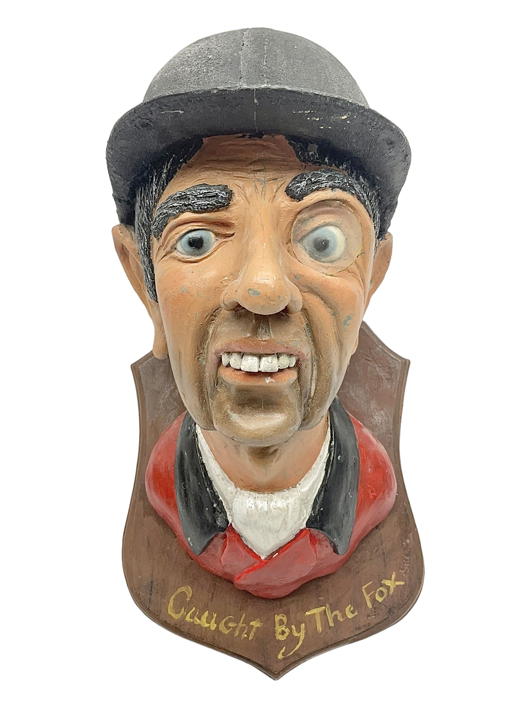 Composite figure of the head of a huntsman on a shield 'Caught by the Fox', D28cm