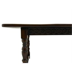 Large oak refectory dining table, rectangular top over guilloche carved frieze rails, turned supports joined stretchers