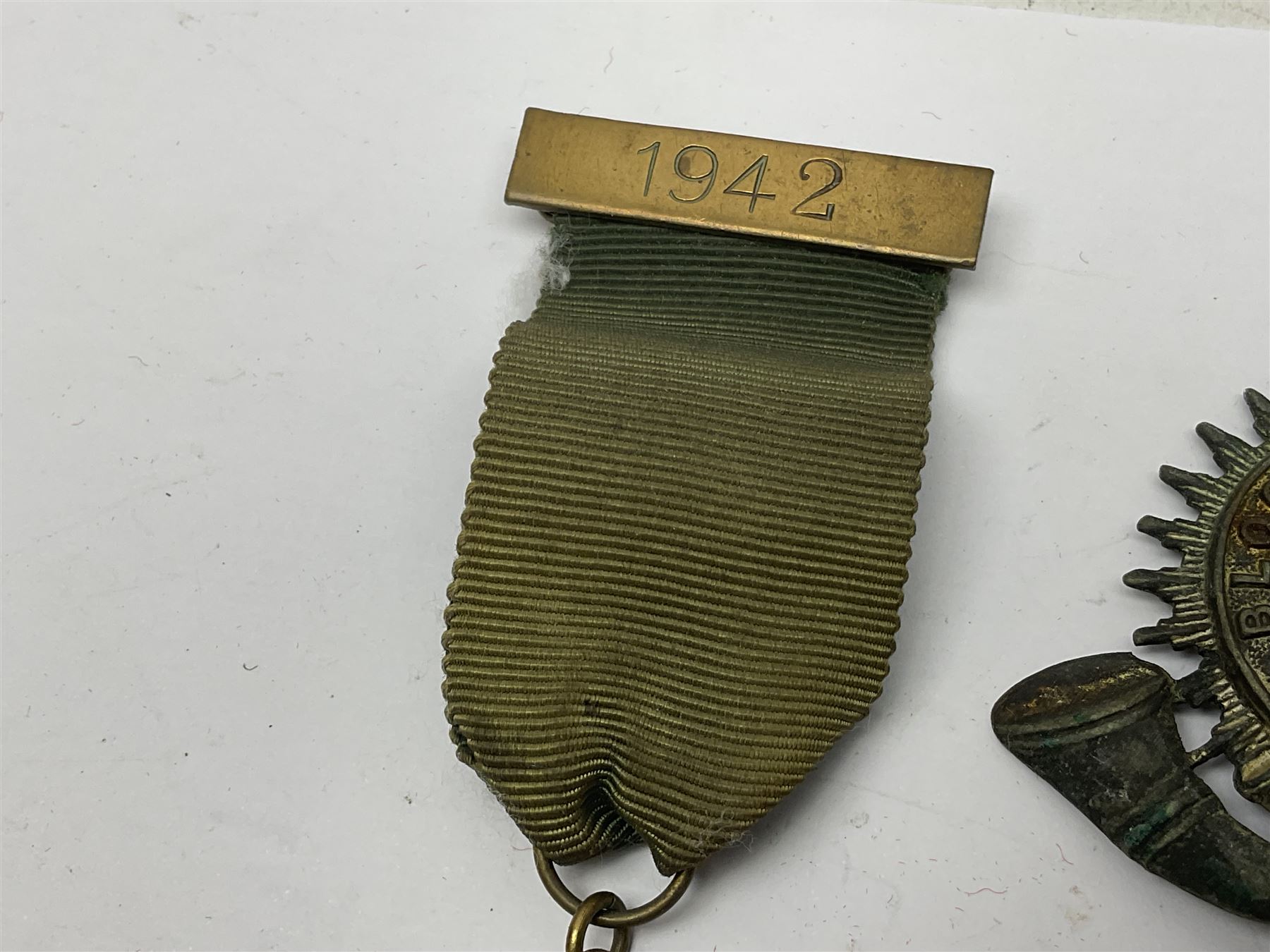 Made-up group of three WWI medals comprising 1914 Star awarded to 23598 Gnr. F. Jefferson R.G.A., British War Medal and Victory Medal with names removed; with ribbons on wearing bar; 1942 Motorist's Medal and small quantity of cap badges, Royalty badges etc