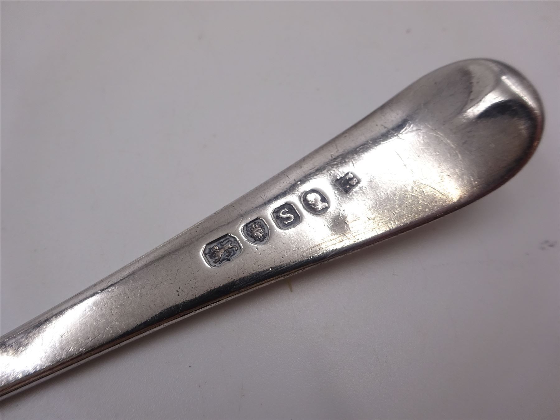 Two George III silver Old English pattern table spoons, the first example hallmarked Peter & Ann Bateman, London 1793, and the second example hallmarked George Smith (III) & William Fearn, London 1792, together with an Edwardian Old English pattern table spoon, hallmarked John Round & Son Ltd, Sheffield 1904, and a similar spoon, maker's mark worn and indistinct (4)