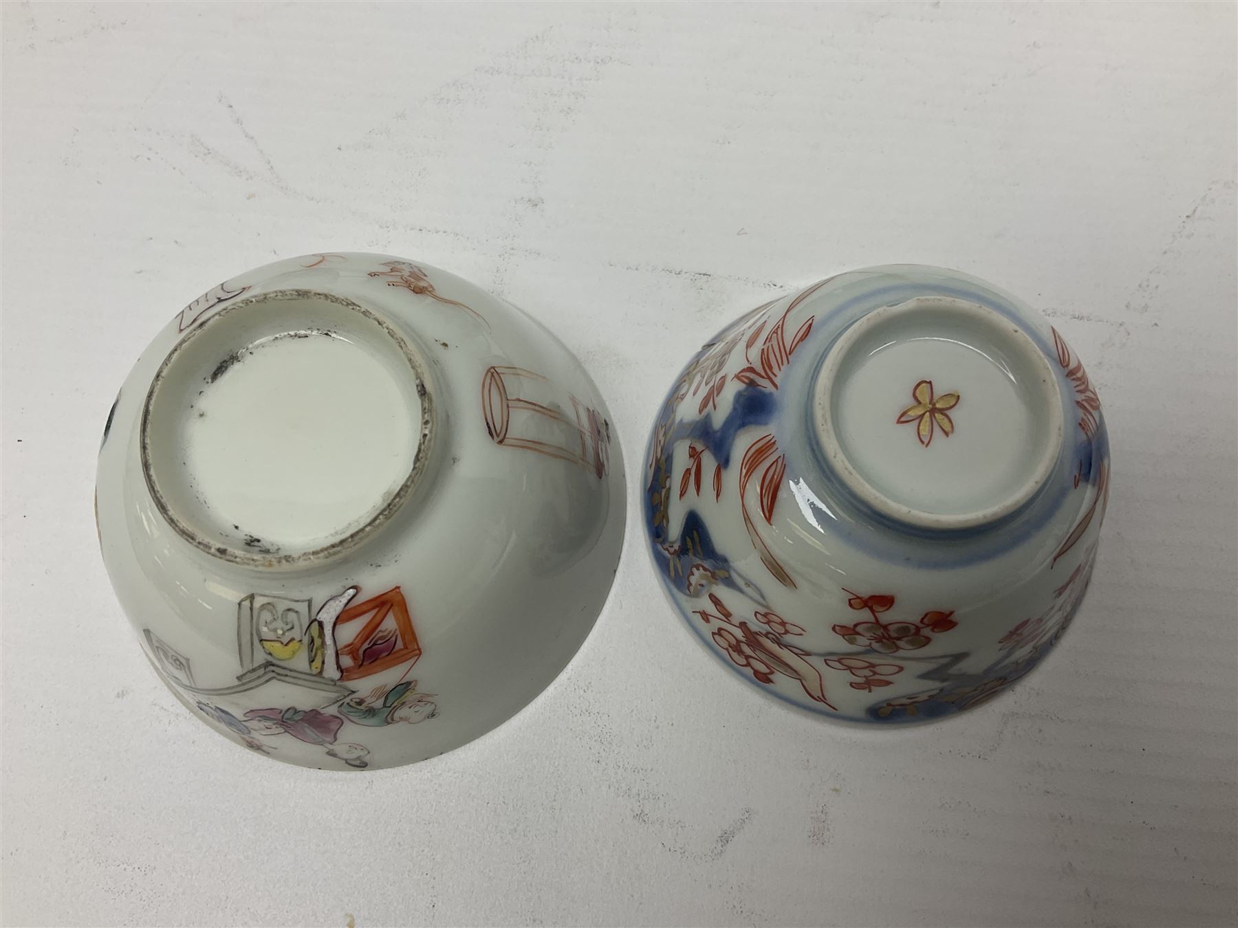 Two 18th century Chinese Yongzheng coffee cups, the first example decorated in polychrome enamel with rooster amidst blossoming peonies, the second decorated with deer and crane among rockwork and pine tree, together with two further 18th century Chinese coffee cups, an 18th century Chinese tea bowl, and a further tea bowl