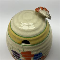 Clarice Cliff for Newport Pottery honey pot, modelled as a beehive and painted in the Crocus pattern, the lift off lid with bee finial, with green printed mark beneath, H9.5cm