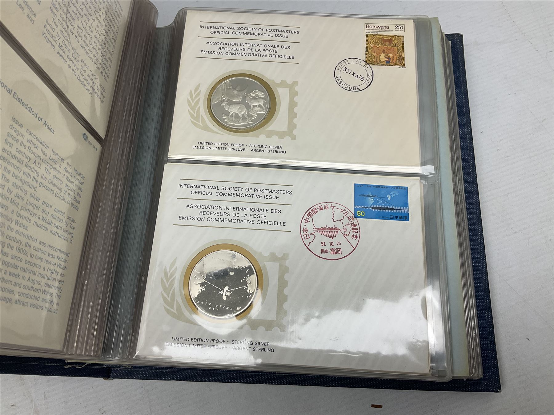 Thirty-six 'International Society of Postmasters Official Commemorative Issues' sterling silver proof medallic covers dating from 1975 to1977, housed in the official folder