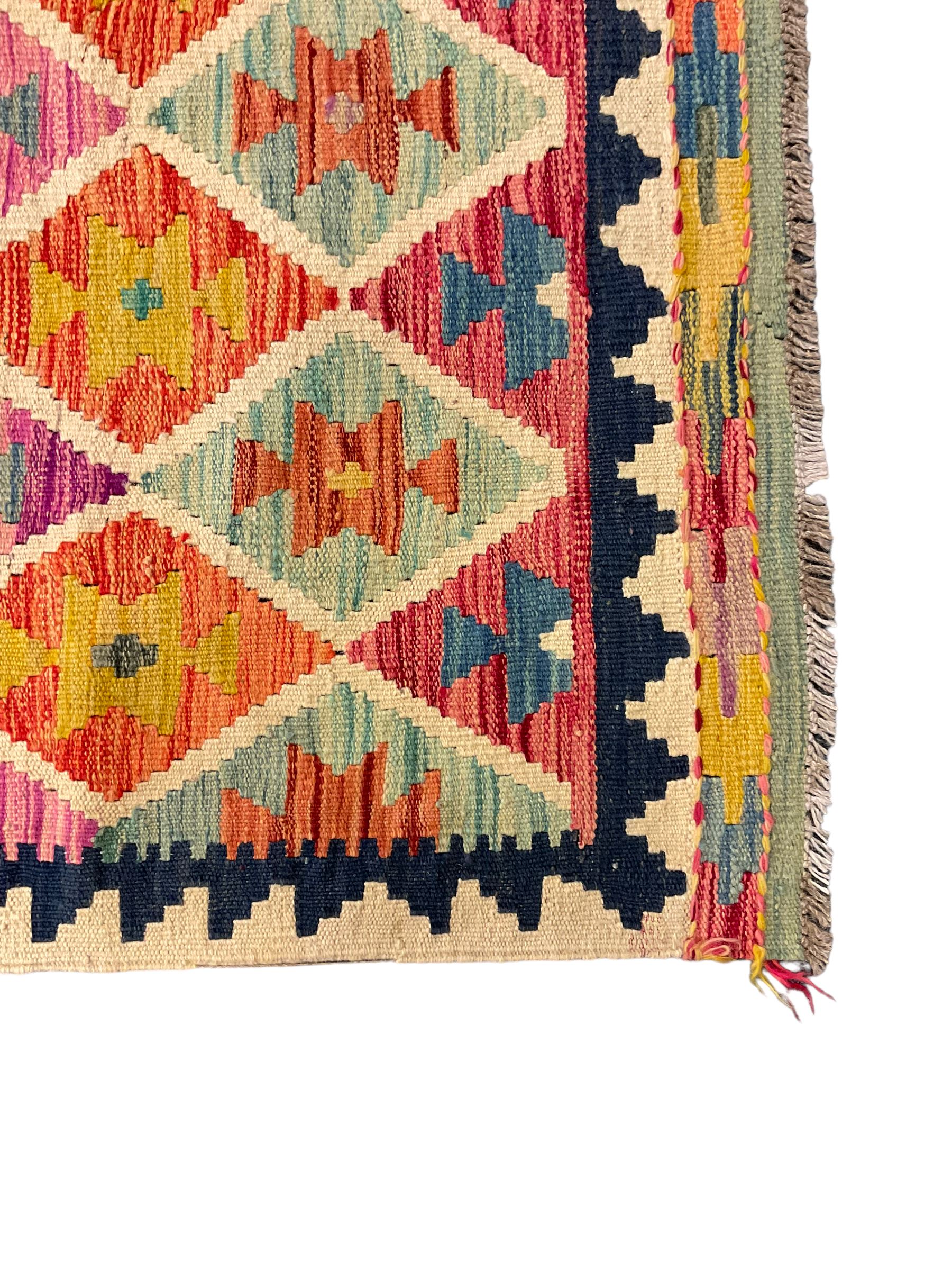 Anatolian Turkish Kilim ivory ground runner rug, decorated with all over multi-colour geometric lozenges with ivory outline