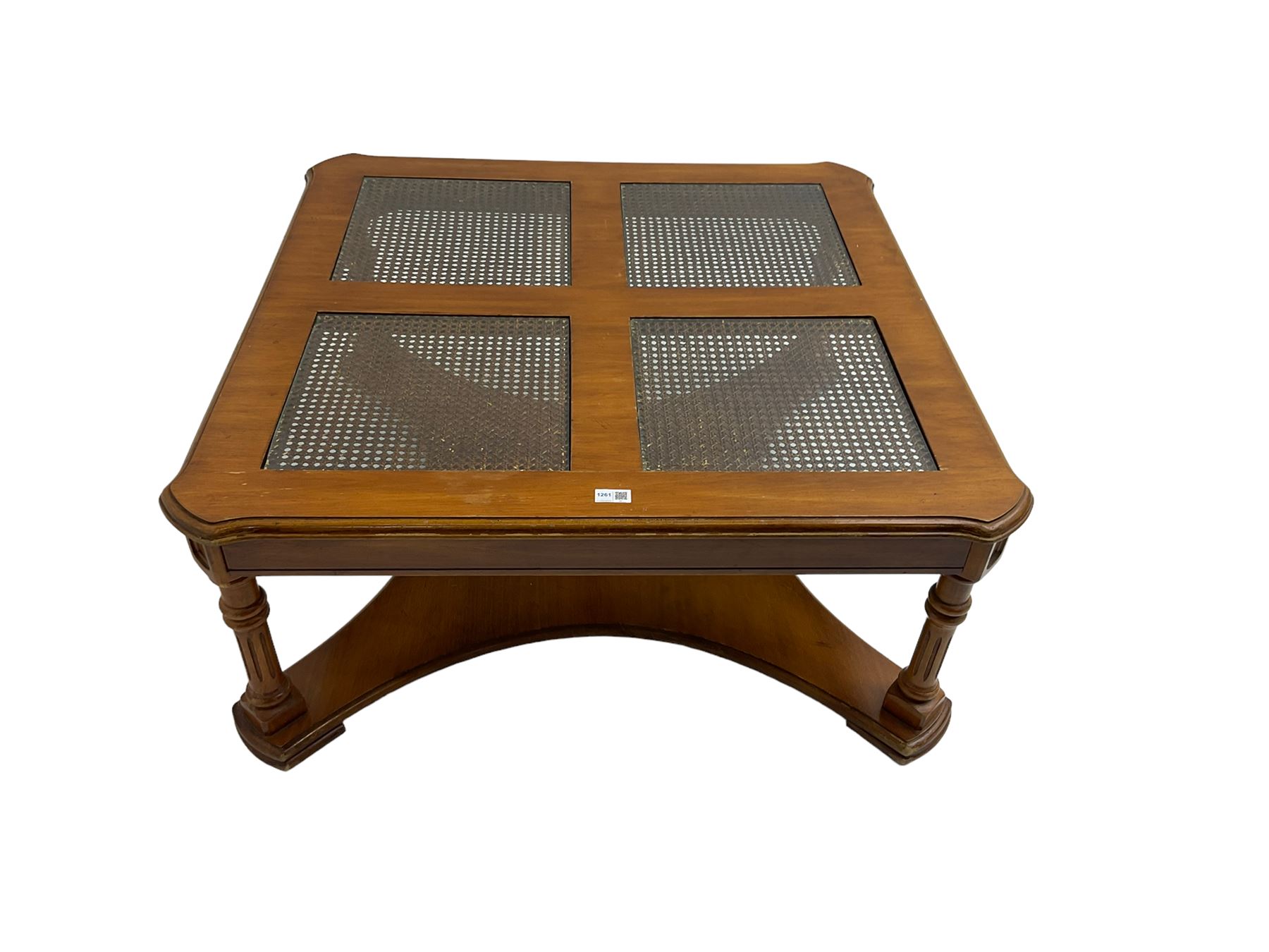 Coffee table, square top with cane work insets, raised on four fluted column supports joined by shaped base