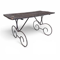 Cast iron garden table, with rectangular weathered slatted wooden top, raised on iron strapwork supports of scrolling form, in black painted antique finish 