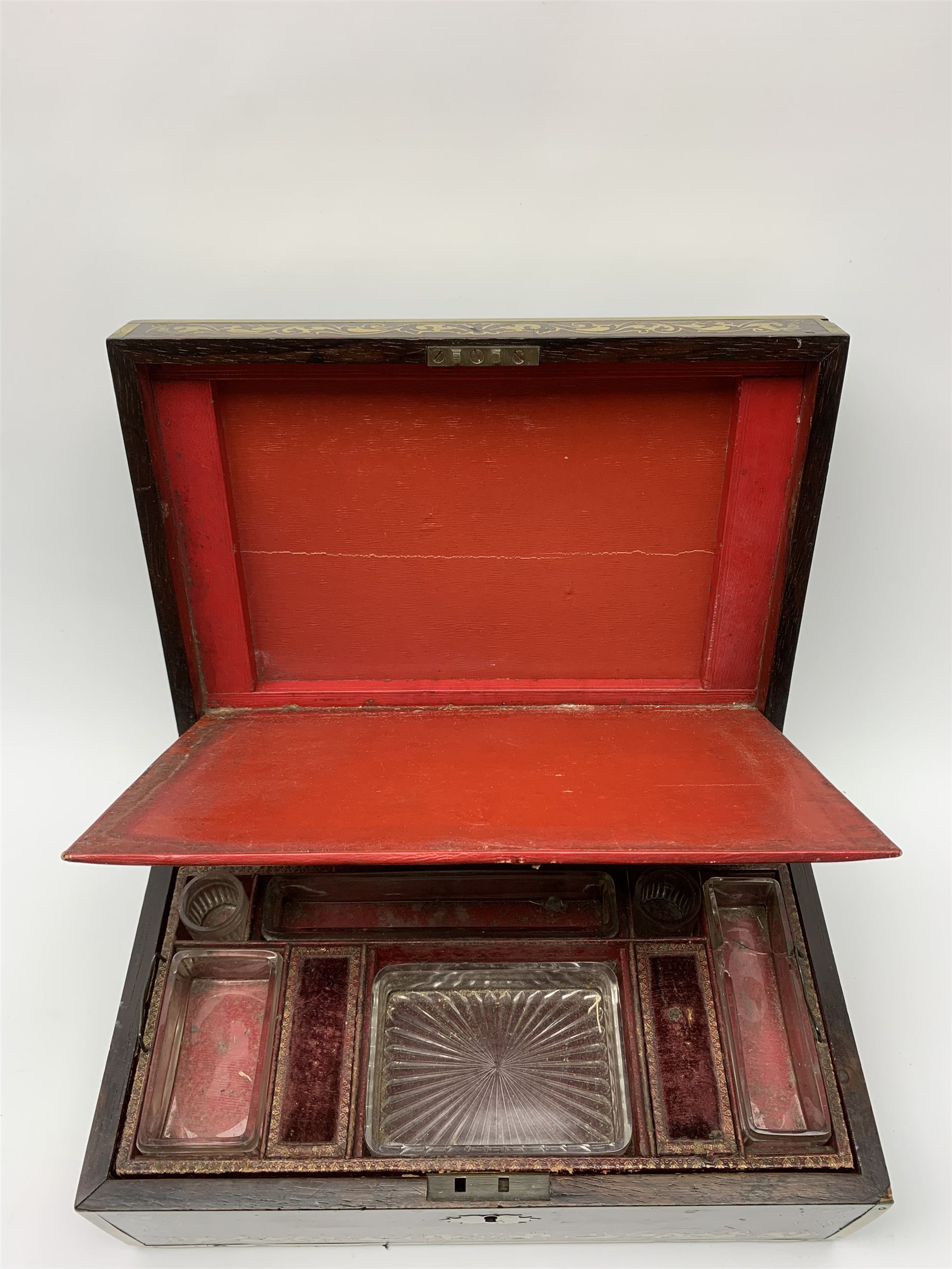Victorian rosewood vanity box, with scrolling foliate brass inlay and twin brass inset campaign style handles, the hinged cover opening to reveal a gilt tooled interior with divisions, L33cm D22.5cm H13cm
