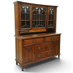 Arts and Crafts oak dresser, projecting moulded cornice above three glazed panels with col...