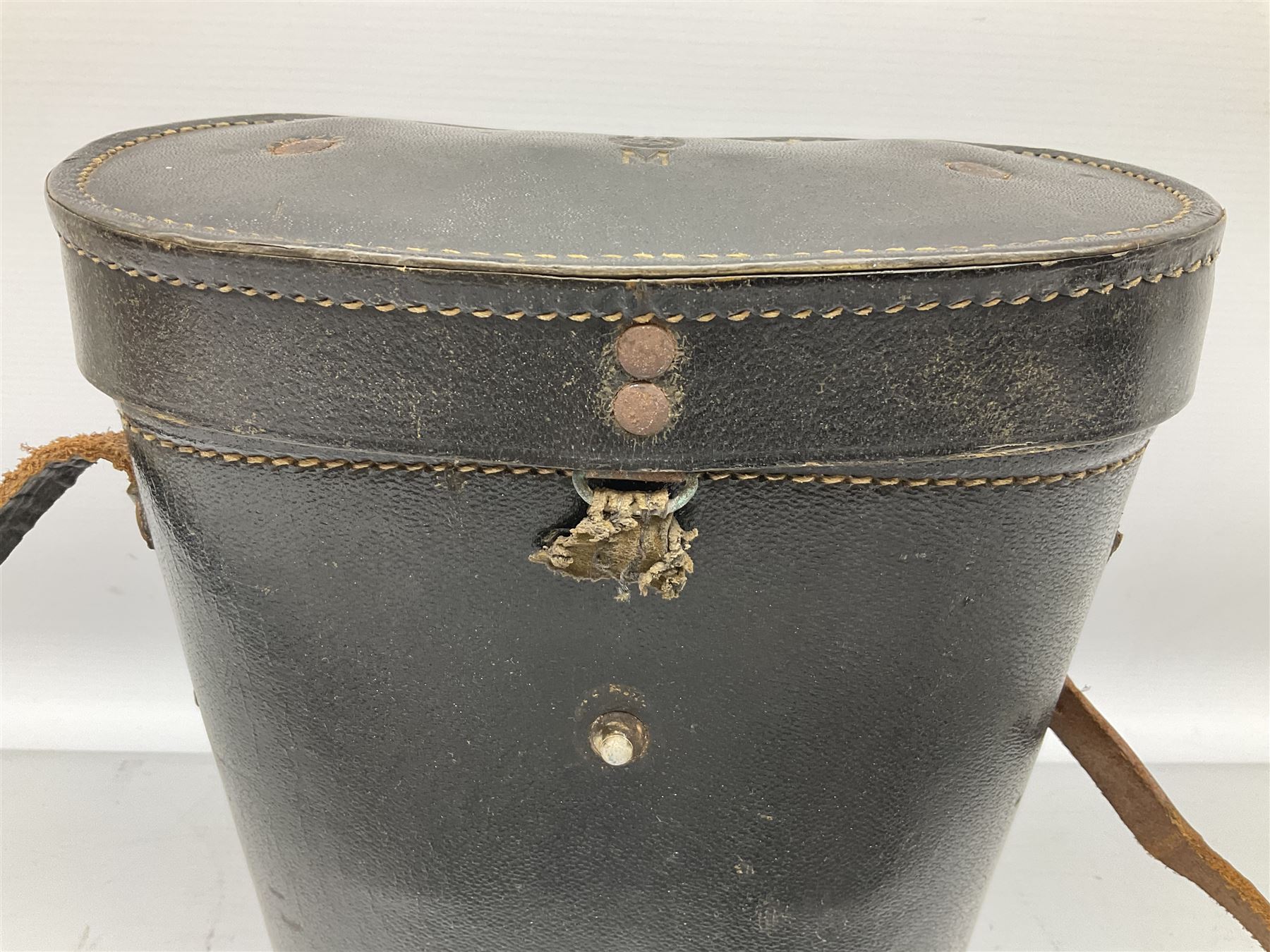 Pair of WWII German U-boat binoculars probably 7 x 50 by Leitz, with rubber eye piece protector covers and leather case stamped with Kriegsmarine mark to the lid and dated 1944, with leather strap.