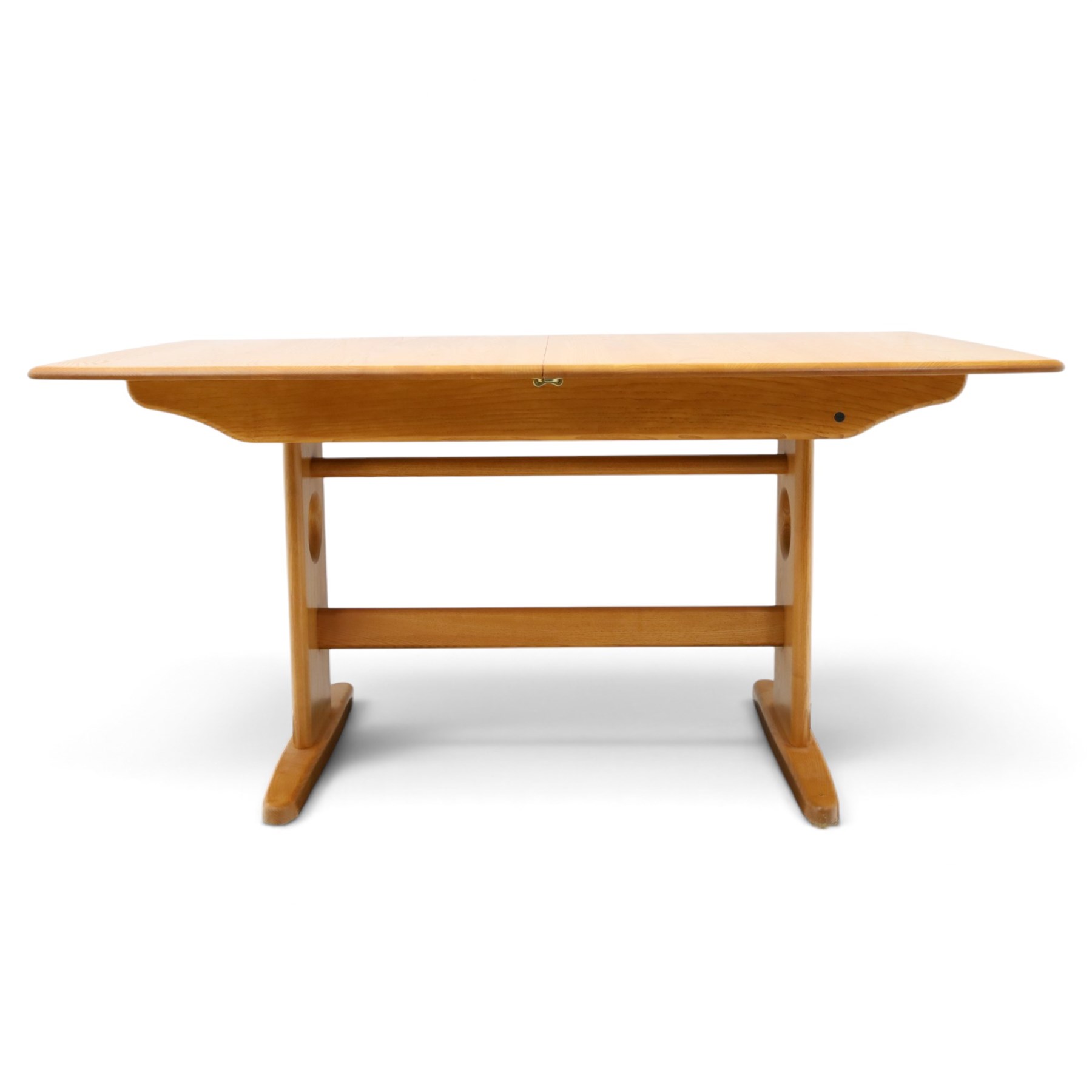 Ercol - 'Windsor' ash medium extending dining table, with stowed fold over leaf extending to 200cm, shaped supports with roundel aperture, united by a stretcher
