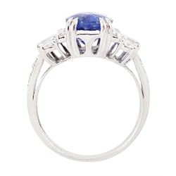 18ct white gold Ceylon sapphire and diamond dress ring, single oval cut sapphire of 4.65 carat, either side set with round brilliant cut and baguette cut diamonds and diamond set shoulders, stamped 750, total diamond weight 0.77 carat, with World Gemological Institute report