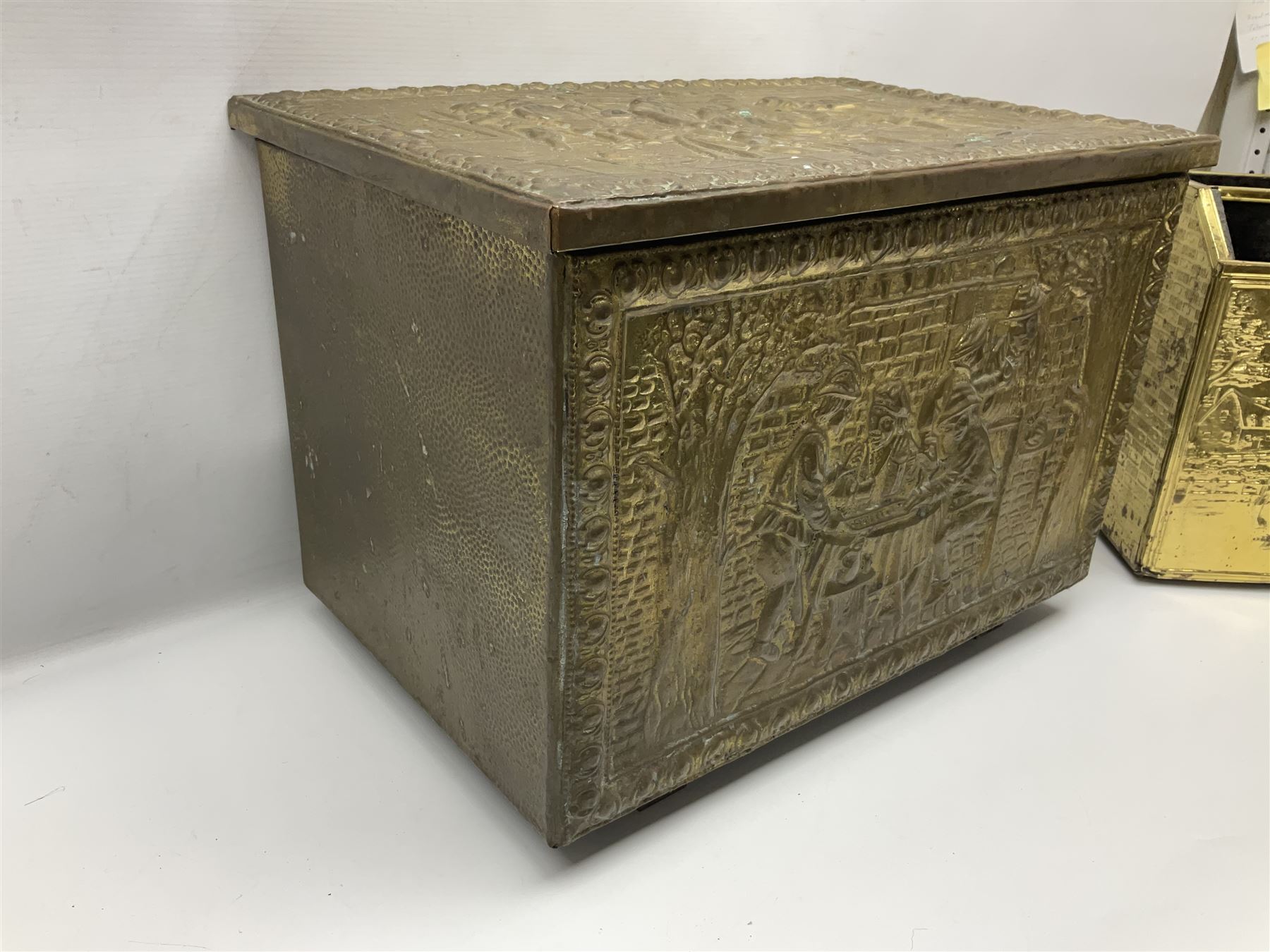 Pair of brass and iron fire dogs, together with brass coal box embossed to the lid with figures and a brass magazine rack, coal box H32cm