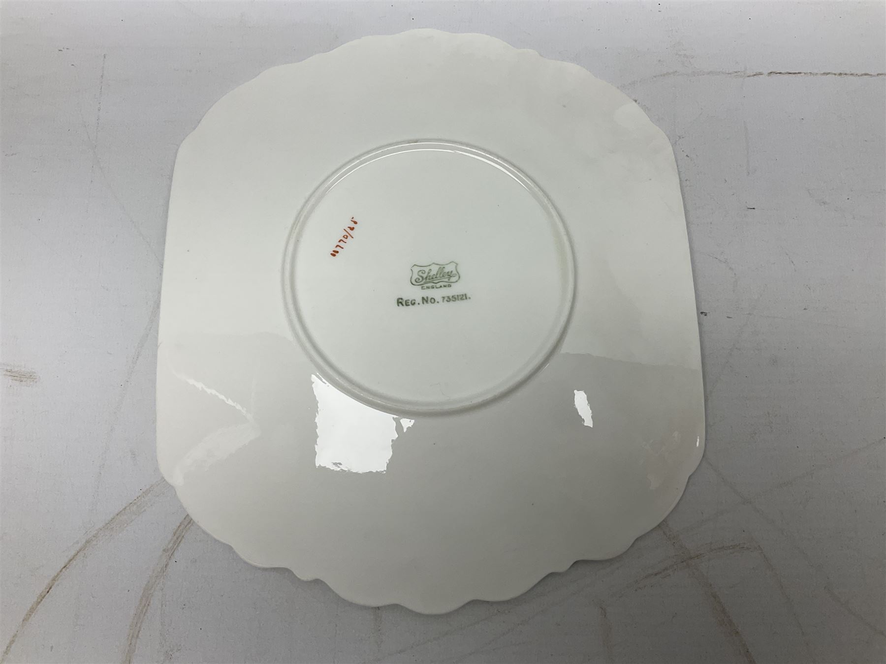 Shelley Dainty pattern tea wares, of lobed form with blue star decoration on merging white and yellow ground, comprising five teacups, five saucers, six tea plates, milk jug and cake plate, all with printed green mark beneath, some with painted pattern no 11770