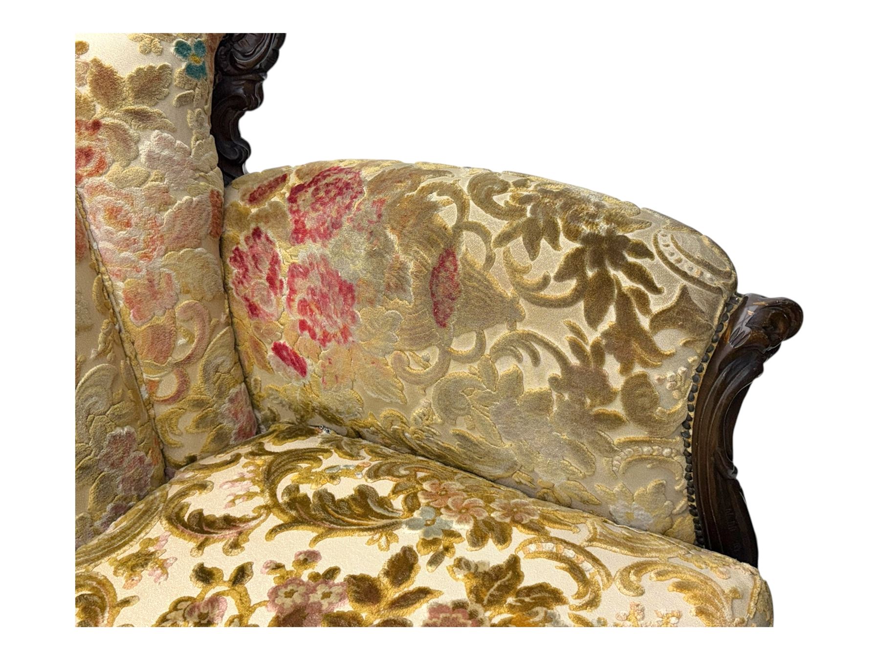 Victorian design stained wood three seater settee, top rail carved and scrolled, padded back and arms, scrolled cabriole feet 