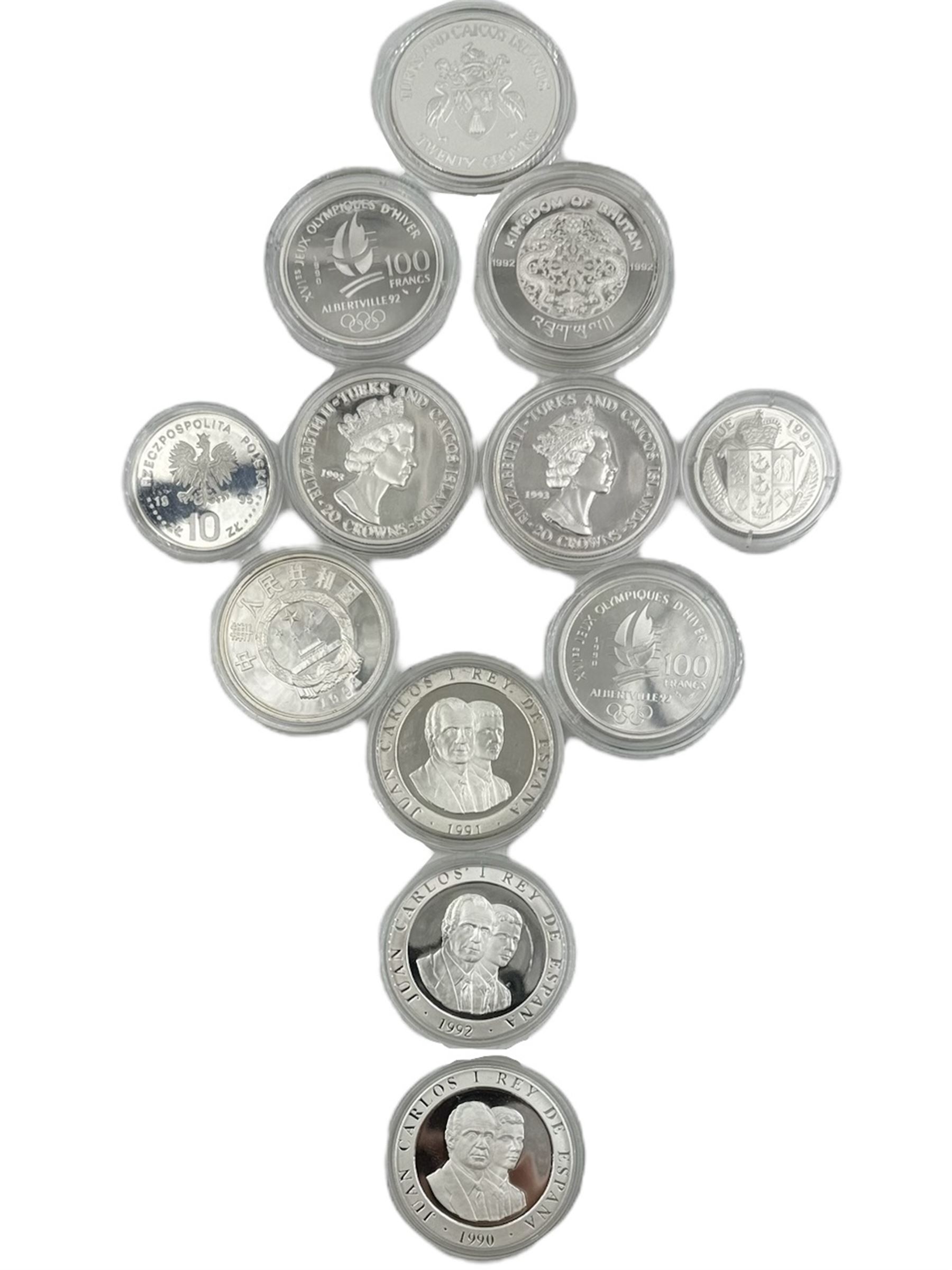Twelve 'Olympic Commemorative' silver coins, including France 1990 'Slalom Skiing' one-hundred francs, China 1992 'Ski Jumper' ten yuan, Bhutan 1992 'Speed Skating' three-hundred ngultrums, Turks and Caicos Islands 1993 'Four-man Bobsleigh' twenty crowns etc, all with Westminster certificates