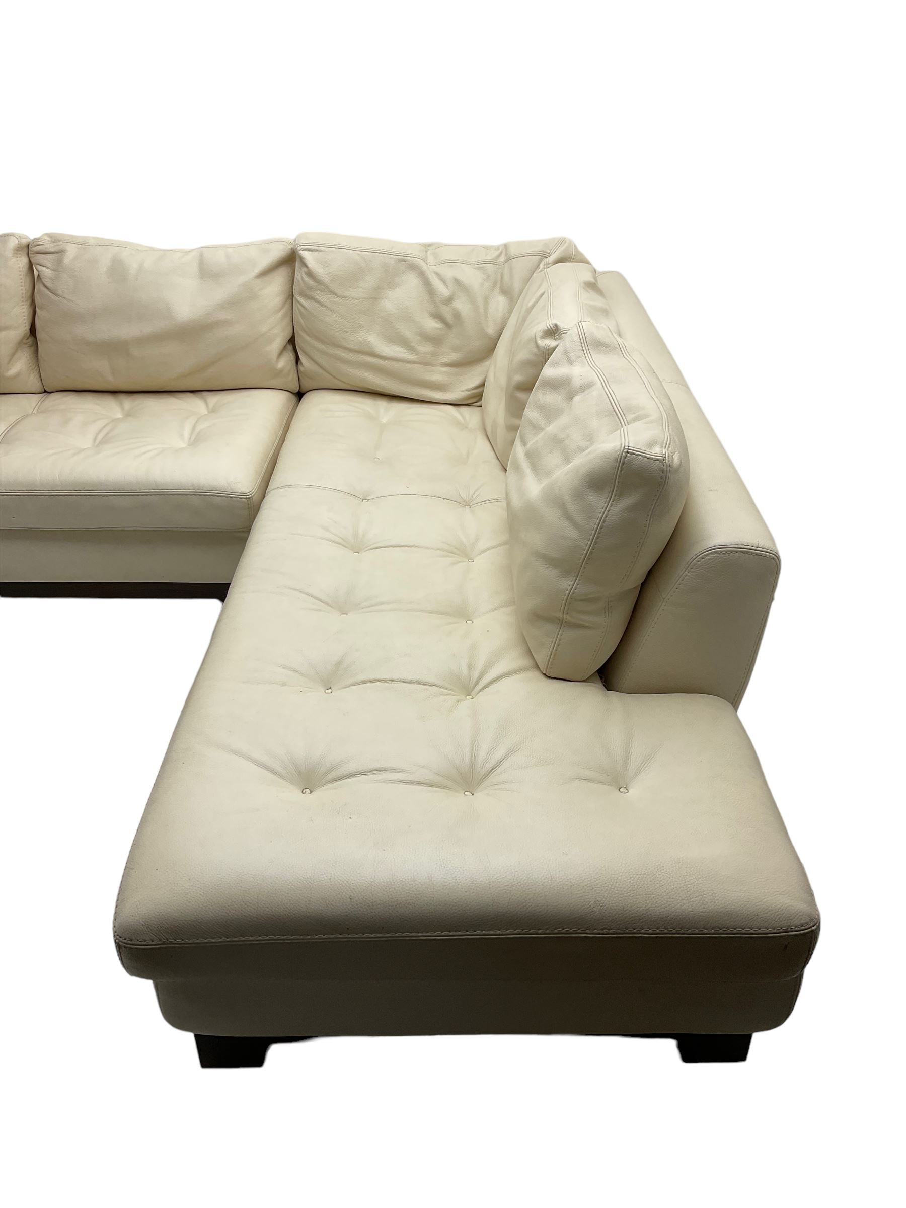 Roche-Bobois - large corner sofa, upholstered in ivory leather with buttoned seat cushions, raised on a stained beech base with bracket feet