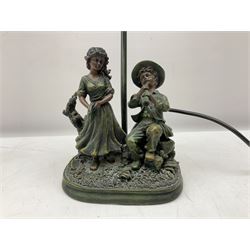 Art Deco style Widdop Bingham & Co desk lamp, modelled as boy and girl playing instruments, on naturalistic base with yellow and green frilled glass shade, with sticker label beneath, H42cm, and A Belcari figural table lamp, modelled as a young gent leaning upon brick wall, on turned wood base, signed, H70cm incl shade, together with bronzed figural table lamp of a lady with parasol upon ornate circular plinth base, two ceramic table lamps and another lamp (6)