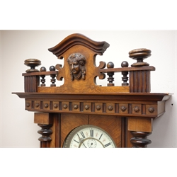  Victorian walnut Vienna wall clock with pierced cresting, circular Roman dial with subsidiary seconds, twin weight movement striking the hours on a gong, H123cm  