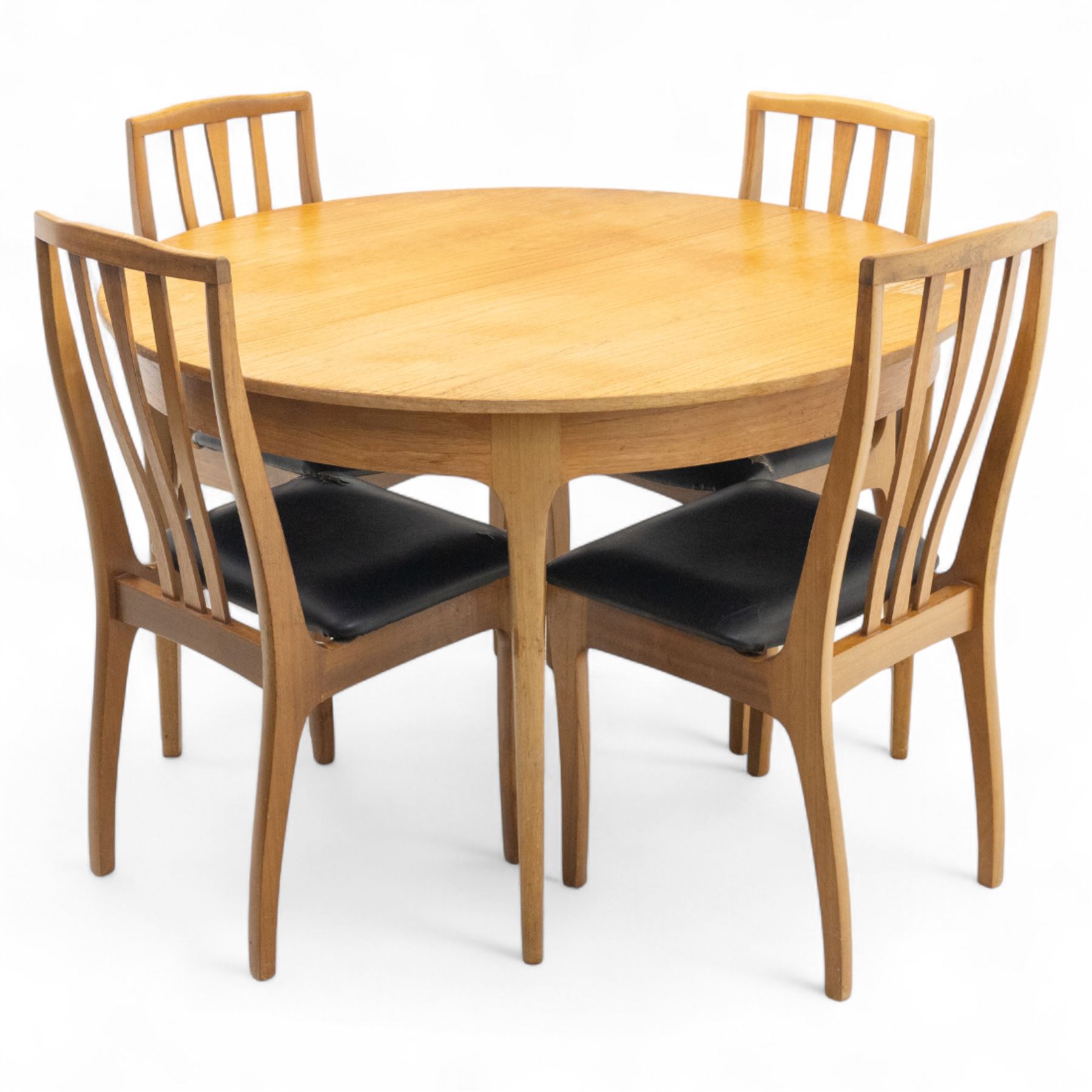 Sutcliffe of Todmorden - mid 20th century ‘S-Form’ teak dining table and chairs, the circular storable extending table with plain veneered top on tapered supports, together with matching dining chairs upholstered in black vinyl, with curved slat backs and shaped front supports, reflecting the sleek organic styling characteristic of 1960s British modern furniture design (Chairs H 93cm, W 46cm, D 46cm) (Extended 168cm)