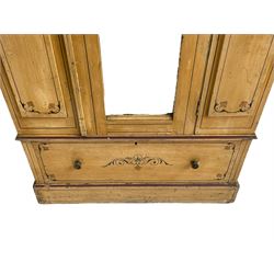 19th century painted pine wardrobe, the projecting cornice over mirror glazed door, with painted decoration depicting scrolling foliate and urns, drawer to base on skirt