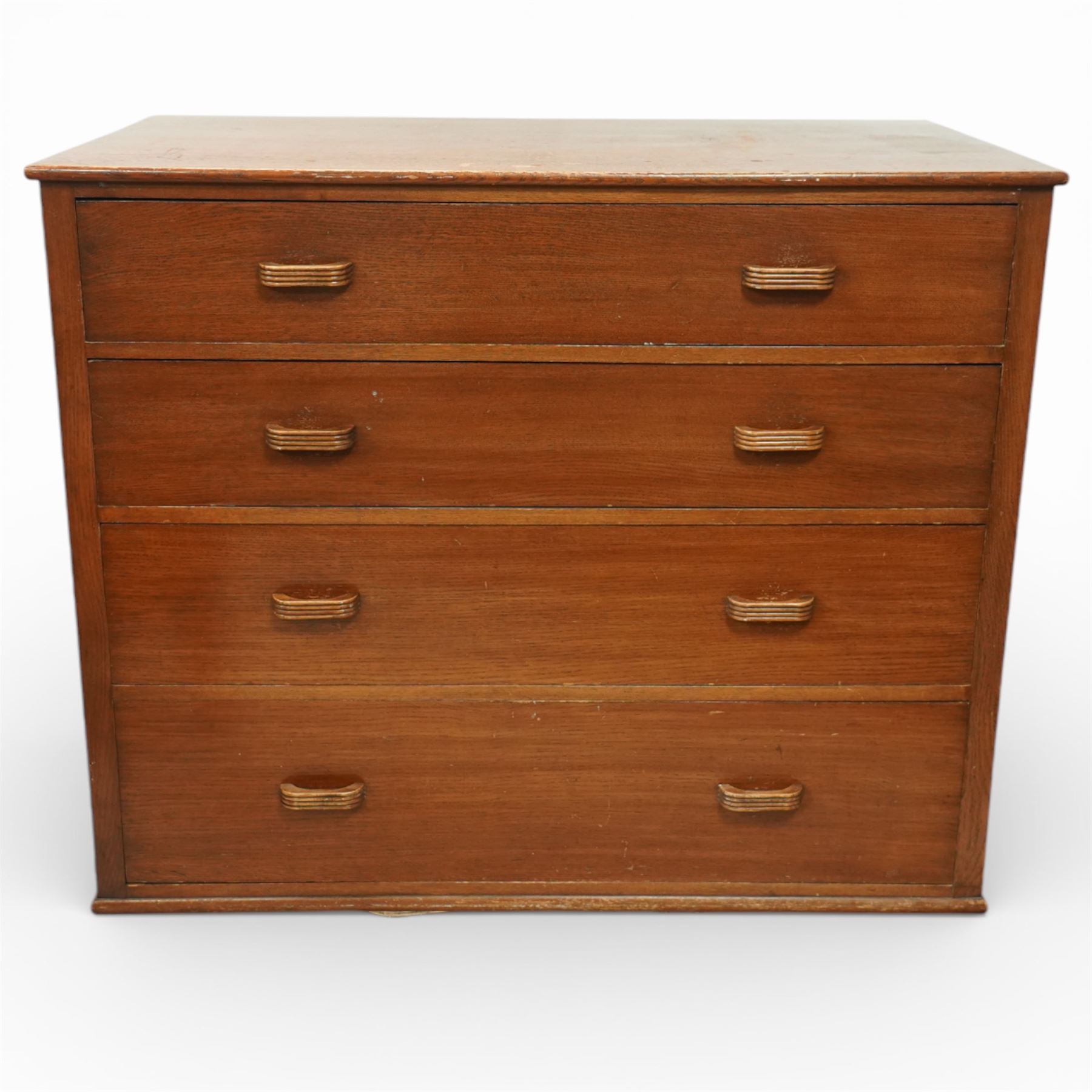 Mid 20th century oak chest of drawers, rectangular top with gently rounded front edge over four graduating drawers fitted with recessed ribbed wooden handles, plain drawer fronts, raised on an integral plinth base