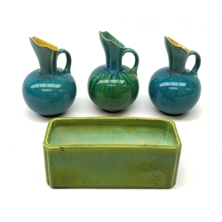 Three Linthorpe pottery jugs, two with turquoise ground, the other with merging turquoise and green, all impressed beneath 1289, H17cm, (a/f), together with a Bretby planter or trough, impressed beneath 2156A, L21cm. (4). 