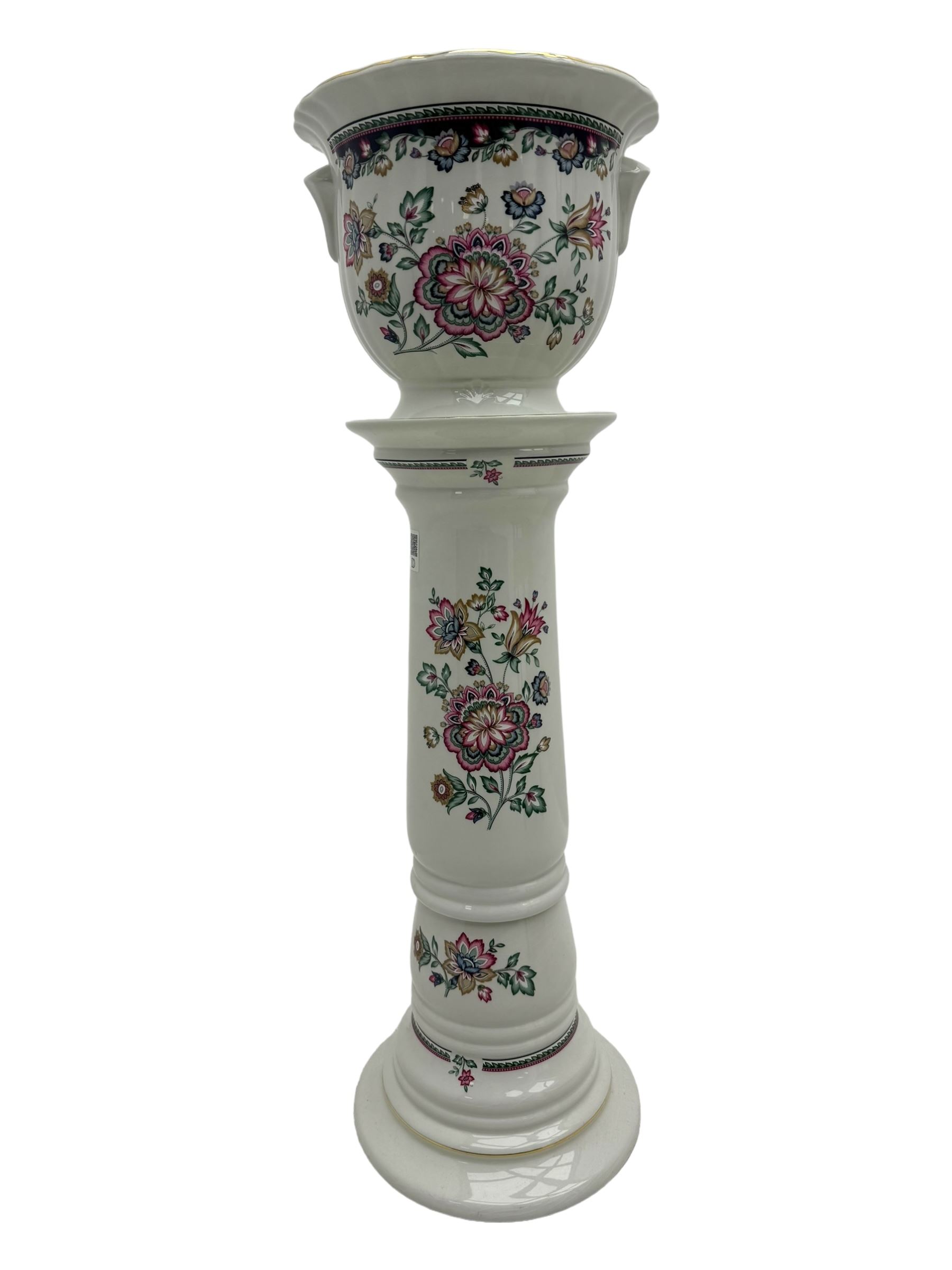 Royal Winton - early 20th century ceramic jardinière on stand, white ground with polychrome floral decoration, flared rim and twin handles, on circular base