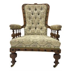 Victorian oak armchair, shaped and moulded frame decorated with ebonised beads, the upholstered arms supported by lobe spindle balustrade, in buttoned floral pattern fabric 