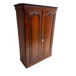 19th century mahogany double wardrobe, foliate carved projecting cornice over banded frieze, two panelled doors with applied carved cartouche moulding enclosing hanging rail with drawer to base, the right fitted with hanging rail over two sliding trays and three drawers