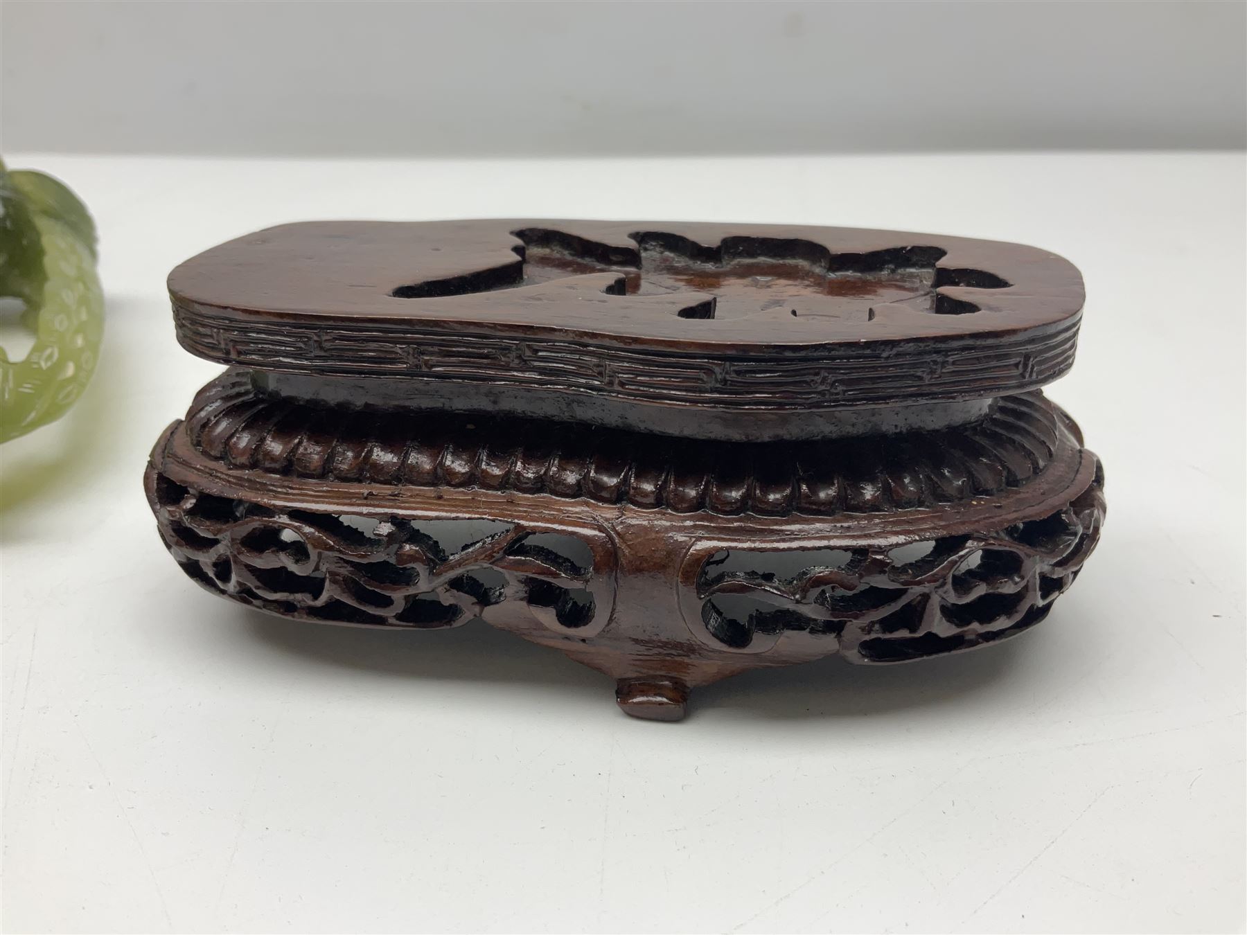 Carved jade figure of a phoenix perched on a flowering branch, upon a wooden stand, with original box, H27cm