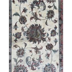 North East Persian Kashmar hand-knotted rug, ivory field with an all-over design of linked floral medallions and scrolling vines with a central circular medallion enclosed by multiple borders and a main broad madder field with palmettes and arabesques, 248cm x 145cm