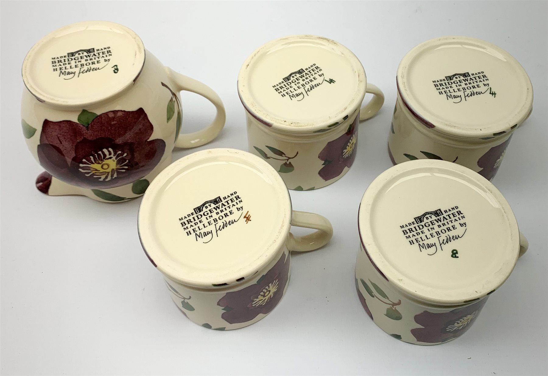 Four Emma Bridgewater mugs, together with a matching jug, each
