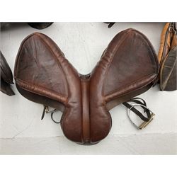 Collection of nine saddles, mainly havana leather to include J.A. Barnsby & Sons saddle, some with stirrups and leathers 