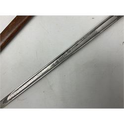 George V 1897 pattern Army Officer's sword by Henry Wilkinson Pall Mall London, the 82.5cm 'London Made' blade etched to both sides with Royal Crests and cyphers etc, pierced half-basket hilt with wire-bound fish skin grip and remains of leather knot strap; in leather covered field service scabbard L101cm overall; and two 14th Prince of Wales Own swagger sticks (3)