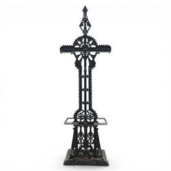 Late 19th century cast iron hall stand in the style of Christopher Dresser, cross shaped upper section with radiating wheel motif and applied hooks, architectural upright with pierced Gothic and geometric detail, fitted with rectangular drip tray and pierced surround, raised on stepped plinth base with bead decoration