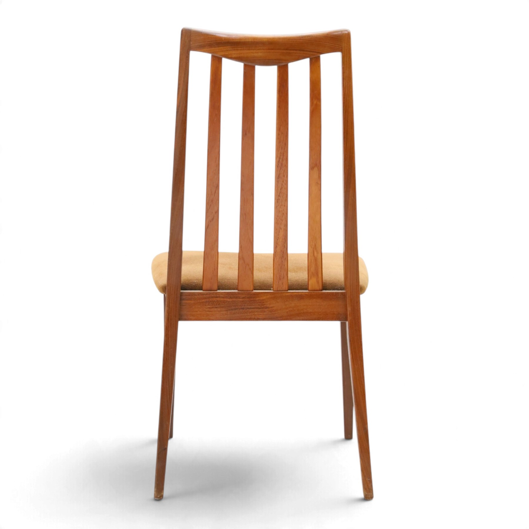 G Plan - Mid 20th century teak extending dining table and four chairs, oval top with stowed fold-over leaf extending to 208cm, raised on two shaped supports united by a stretcher 