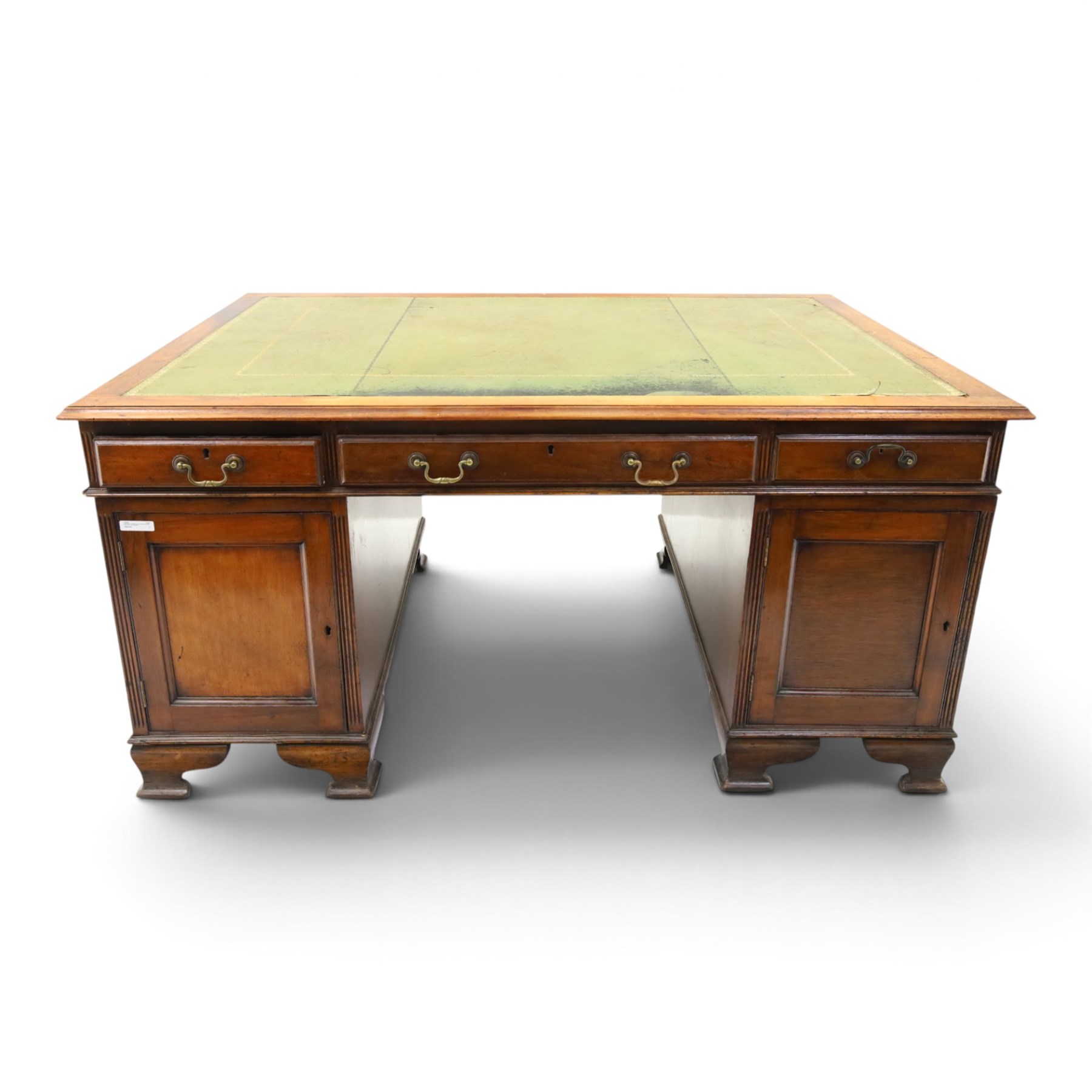 D Matthews & Son Office Furnishers (Liverpool) - Edwardian mahogany twin pedestal partners desk, rectangular top with inset green leather writing surface, fitted with an assortment of twelve drawers with brass swan neck handles, the pedestals with cupboards fitted to the opposing side, raised on ogee bracket feet