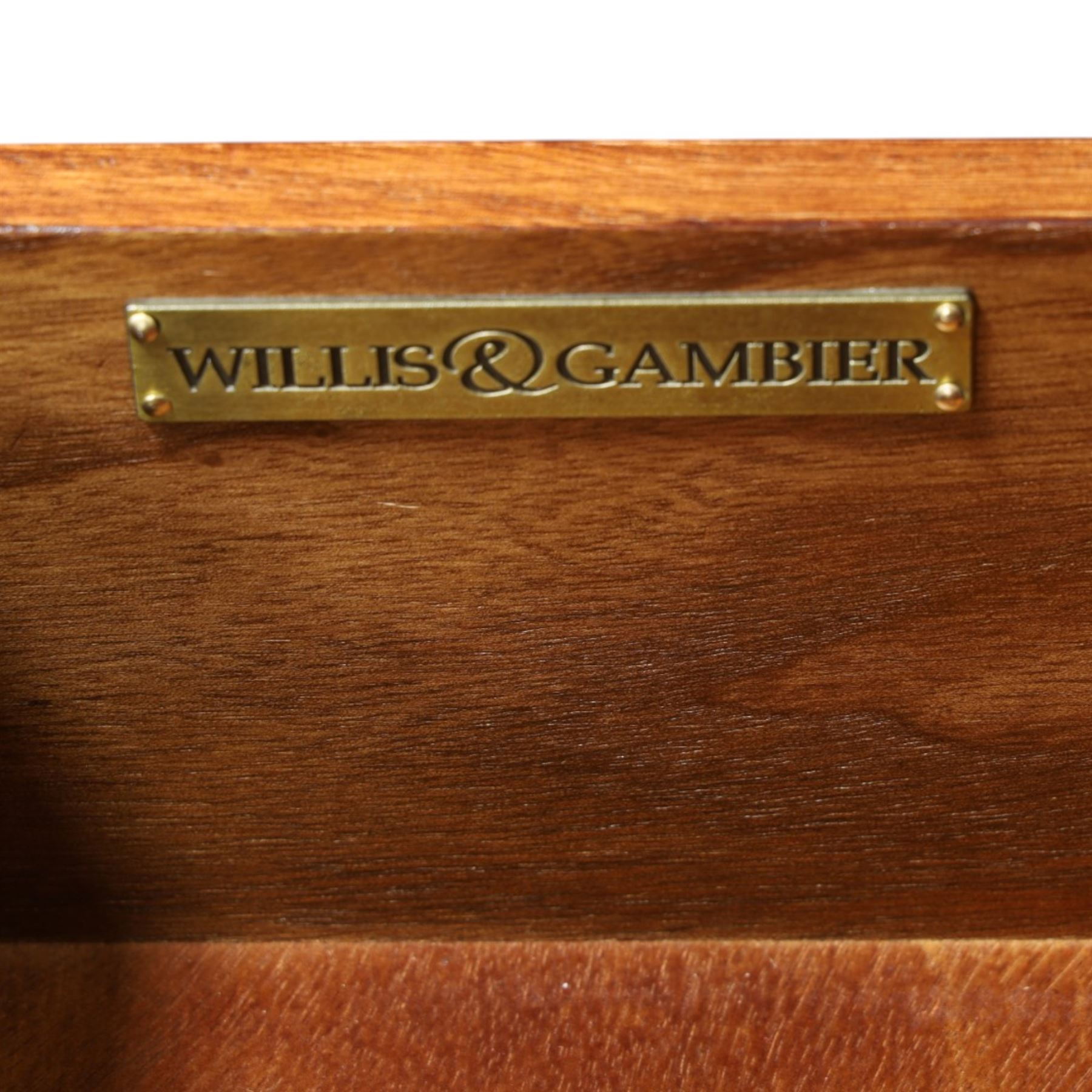Willis & Gambier - mahogany dressing table, three part mirror and stool, the dressing table with rectangular top with chamfered corners, over two baize lined frieze drawers, kneehole recess and a single drawer either side, three part mirror with central tilting mirror on a moulded plinth base, with oval beige padded stool 