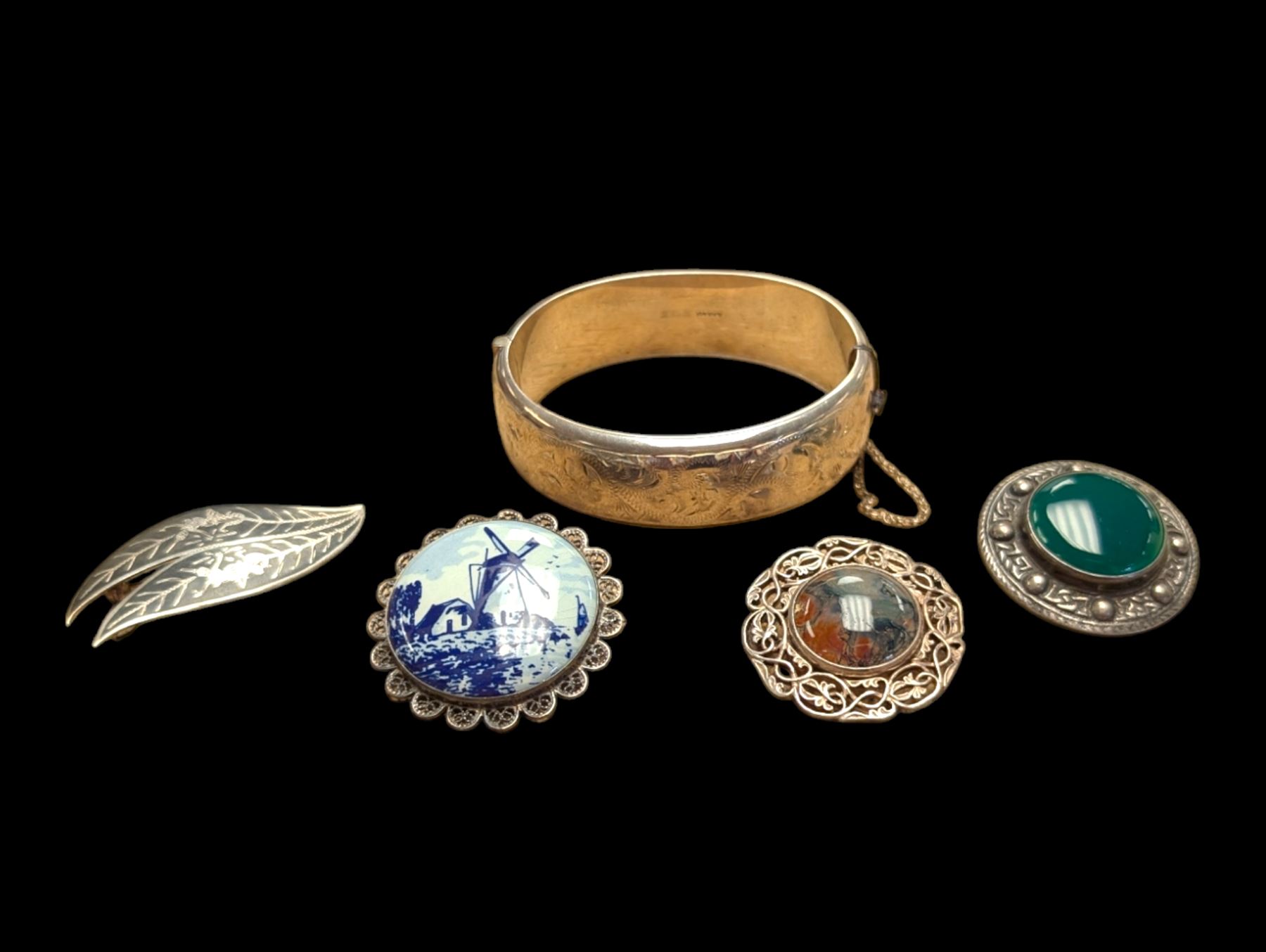 Silver bangle with four silver brooches