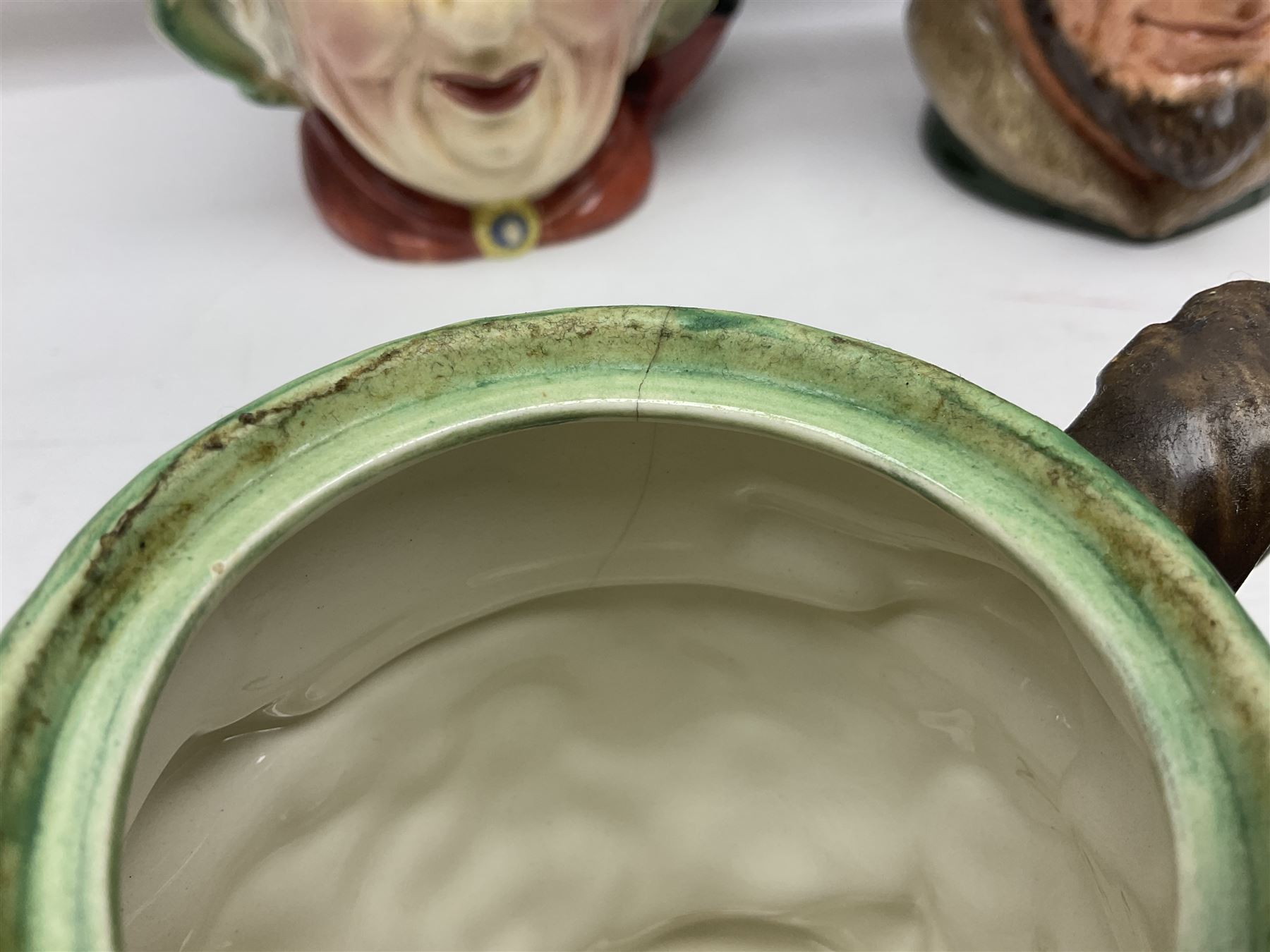 Collection of Royal Doulton and Beswick character jugs of various sizes, including North American Indian D6611, The Falconer D6533,  Tony Weller 281, Sairey Gamp 371 etc