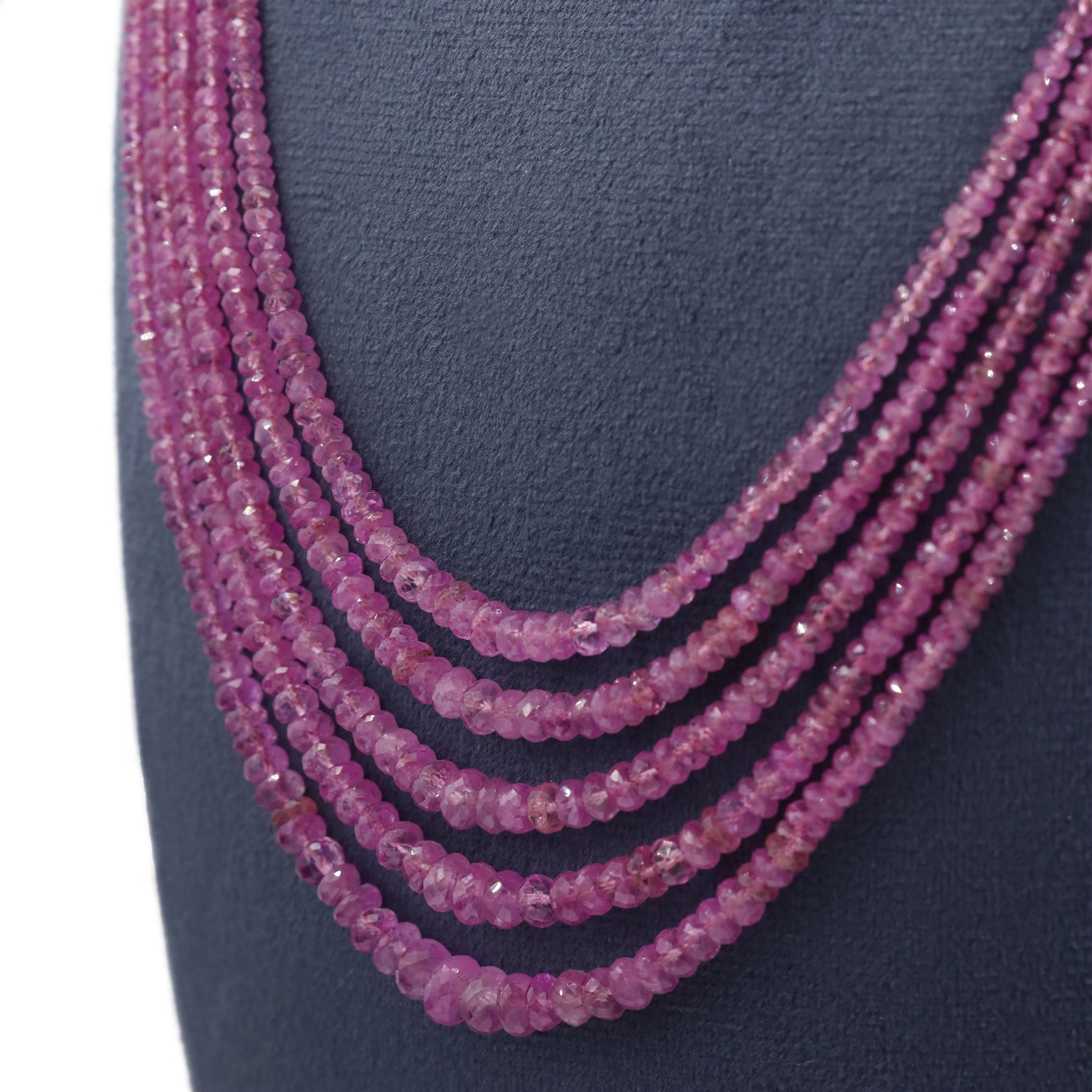 18ct gold pink sapphire necklace, five graduating stands of faceted pink sapphires, with an 18ct gold clasp, London 2004