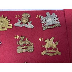 Thirty-two cap badges including Parachute Regiment, Grenadier Guards, East and West Yorkshire, Australian Commonwealth, 3rd Dragoon Guards, various Lancers, Brecknockshire, RFC, RAF, Lancashire Fusiliers, Kings Royal Rifle Corps, Inniskilling etc; mounted on two boards for display (2)