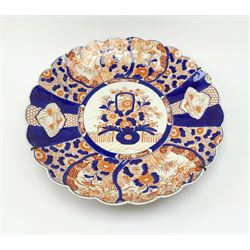 A large Japanese Imari wall charger, of circular lobed form, decorated with panels of flower and birds in the Imari pallet, D46cm. 