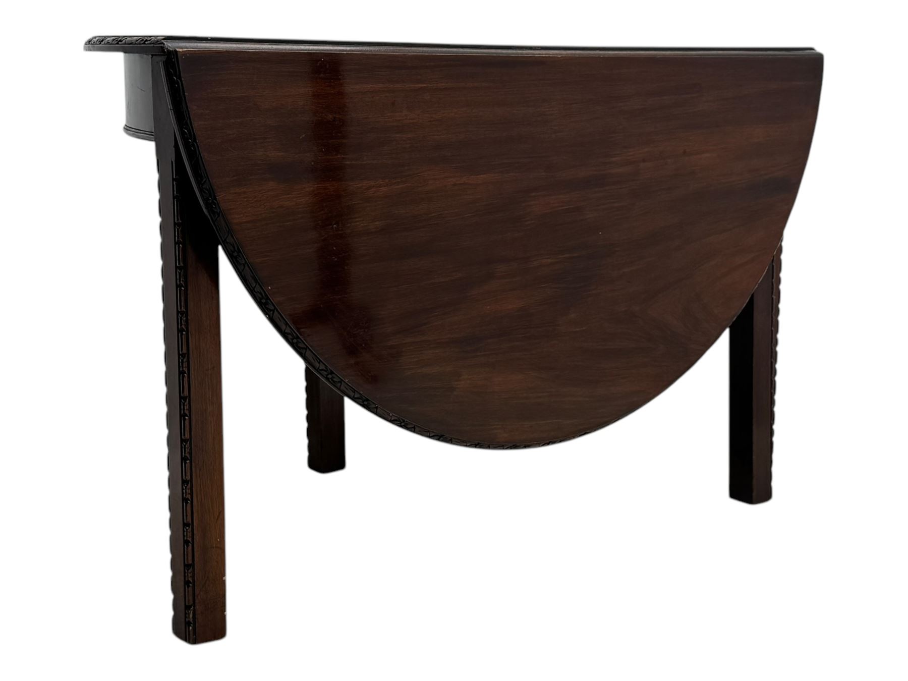 Early 20th century mahogany demi-lune table, the circular top with carved foliate border, raised on square section supports with relief carved edges