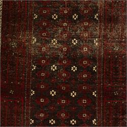 Three rugs,  comprising a Baluch rug in crimson ground, 179x97cm, a Tekke Bokhara rug in crimson ground, 201x132cm, and a Bokhara rug in ochre ground, 125x175cm 