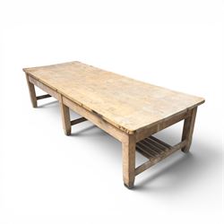 Large early/mid-20th century pine table or work bench, rectangular six plank top on eight tapering supports joined by slatted undertier