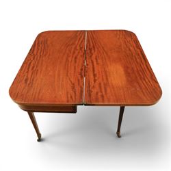 Regency mahogany fold-over tea table, rounded rectangular top with gateleg action, inlaid and crossbanded frieze, raised on squared tapering supports on brass castors