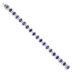 18ct white gold sapphire and diamond bracelet, nineteen clusters each set with a single ov...