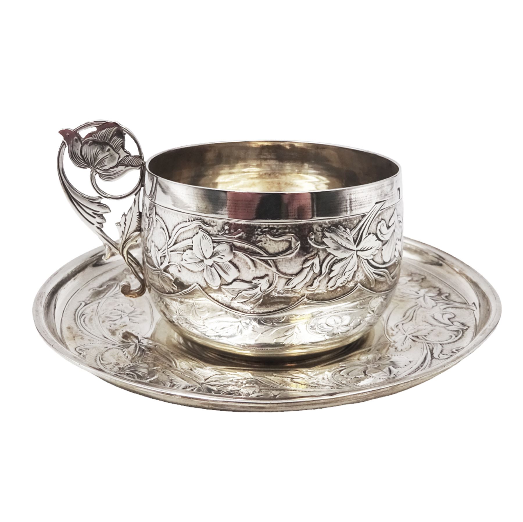 French silver cup and saucer, with embossed floral decoration throughout and openwork floral handle, stamped with Minerva's head and maker's mark for 	P. Fres Paris, cup H5.5cm